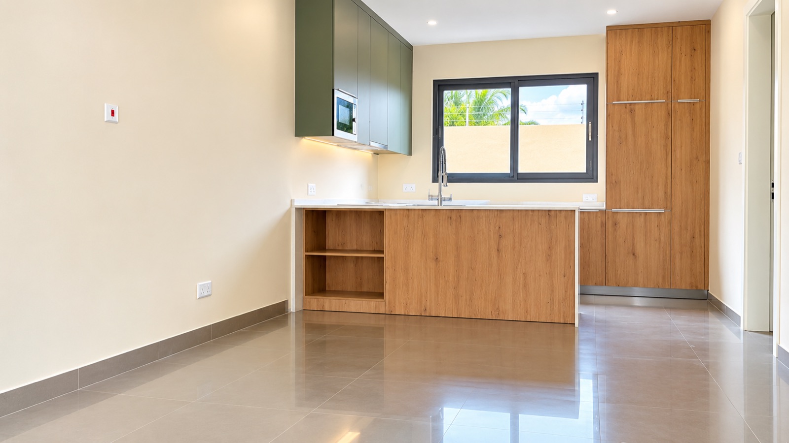 Kitchen with timber cabinets, green upper units and a tiled floor — after