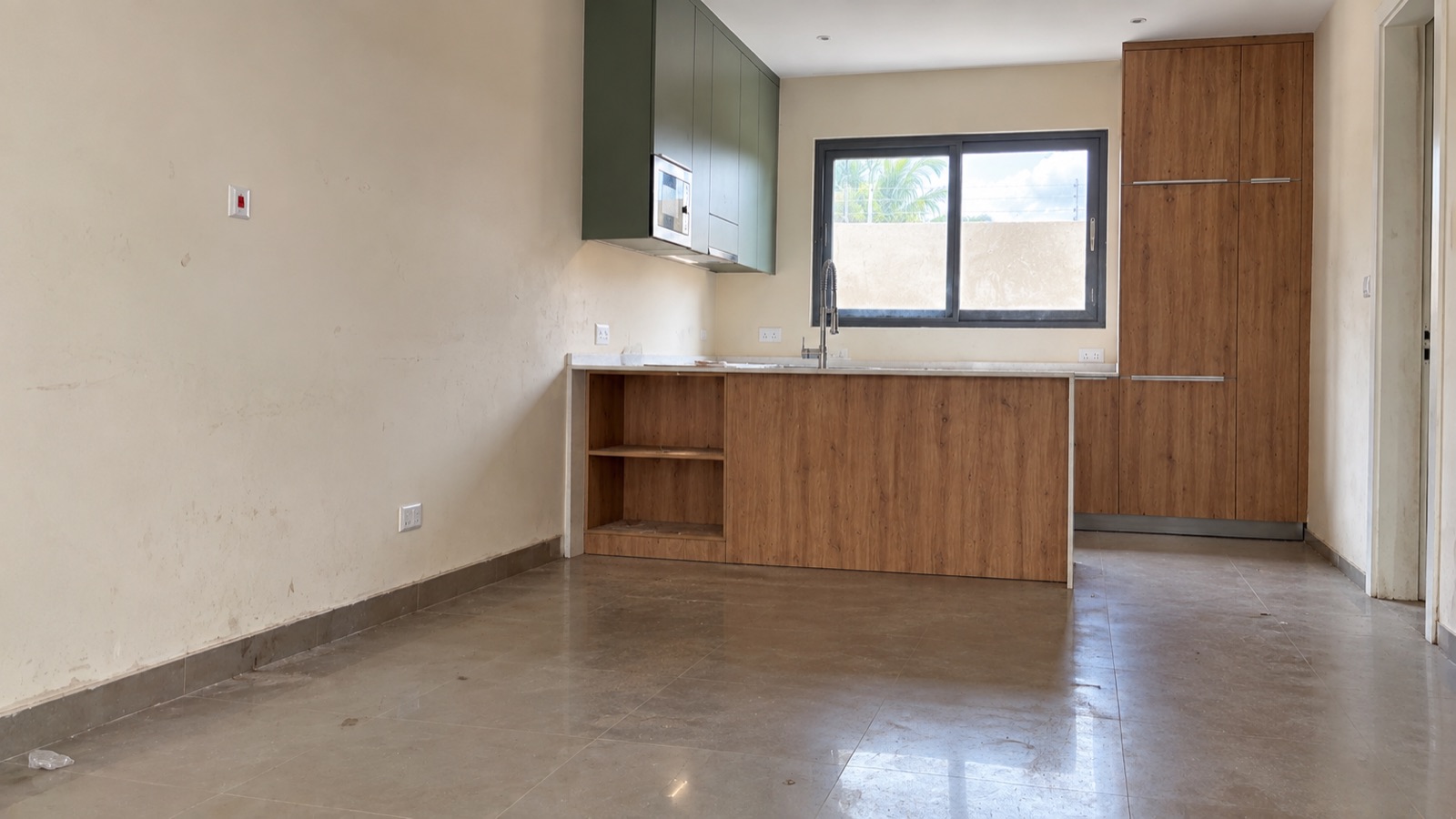 Kitchen with timber cabinets, green upper units and a tiled floor — before